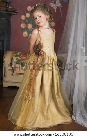Blond Flower girl wearing a golden dress with beadwork