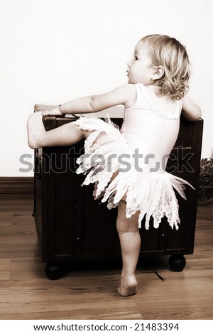 Little girl with short hair wearing a pink ballet outfit