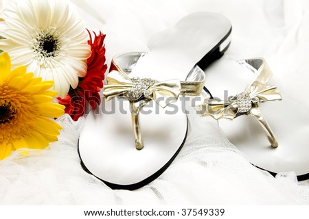 stock photo Silver and gold wedding sandals with daisies