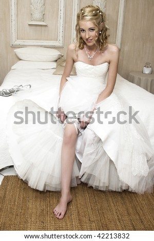 Beautiful Blond bride wearing diamond jewelery and a white gown