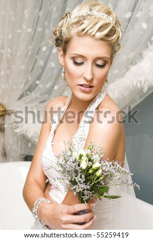 Beautiful Blond bride wearing diamond jewelery and tiara