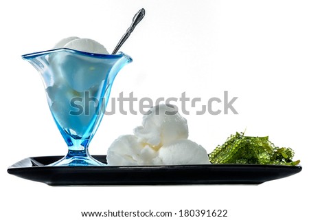 isolated seaweed ice cream scoops served on a black sushi plate with negative space for copy-writing