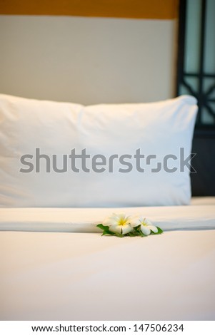 White tropic flower on hotel bed in Thailand