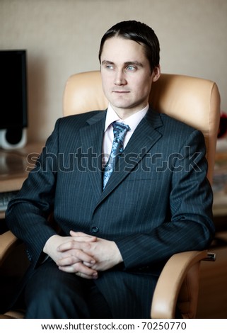 Young man in suit in office