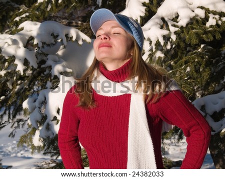 girl breathes cool air in wood