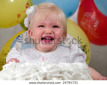 girl laughs before cake for birth day