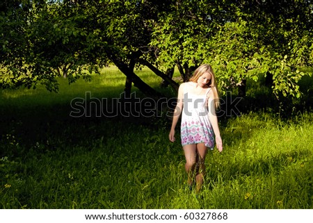 beauty woman goes on garden at spring
