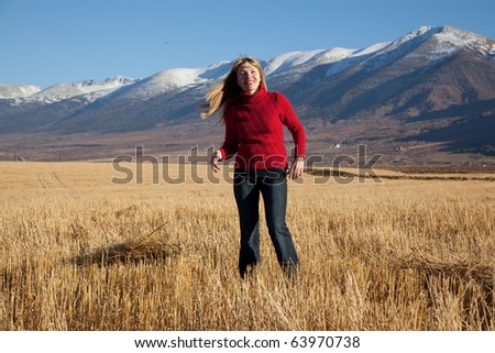 beauty woman goes on yellow field