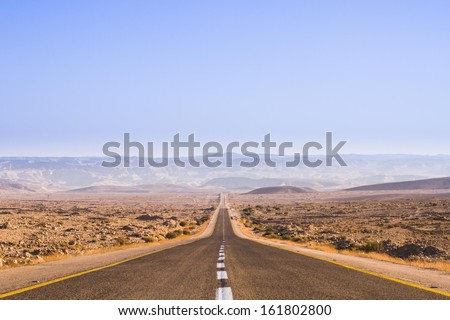 Beautiful road in the desert, going beyond the horizon. Israel