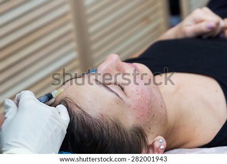 Injections on the face with cosmetic procedures , woman having beauty treatment .