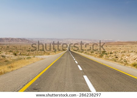 Beautiful road in the desert, going beyond the horizon. Israel .