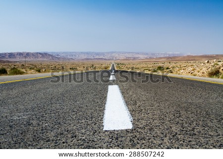 Beautiful road in the desert, going beyond the horizon. Israel .