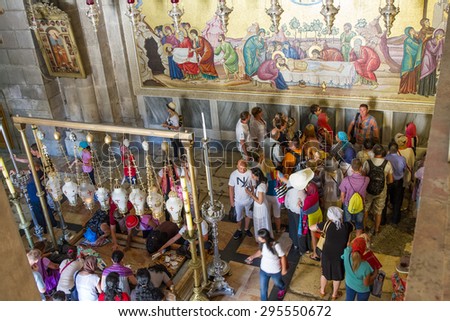 Jerusalem , Israel - July 11, 2015 :  The Holy Sepulchre Church in the Old City of Jerusalem. Stone anointing of the Lord and a fresco of the crucifixion.