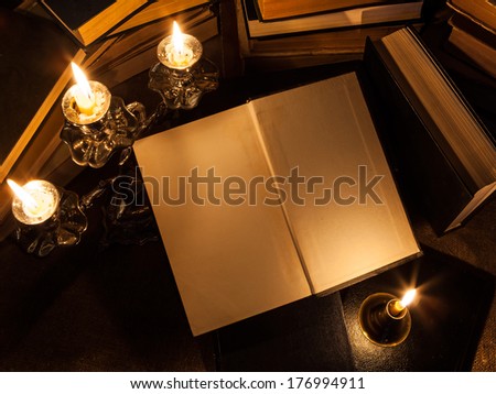composition of books and candles (theme of the day of writer  or day of the copyright)