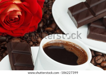Coffee, chocolate and rose on coffee beans
