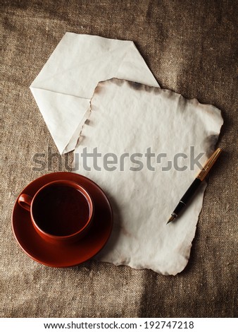 letter and tea in a clay cup