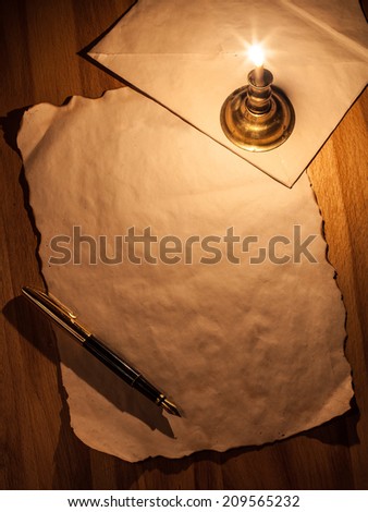 Old paper, pen, candle and envelope
