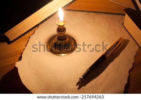 The books, pen, candle and paper