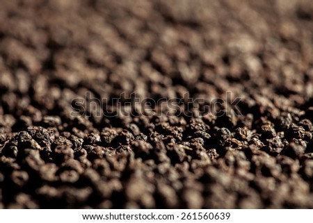 Background of black tea granules (shallow depth of field)