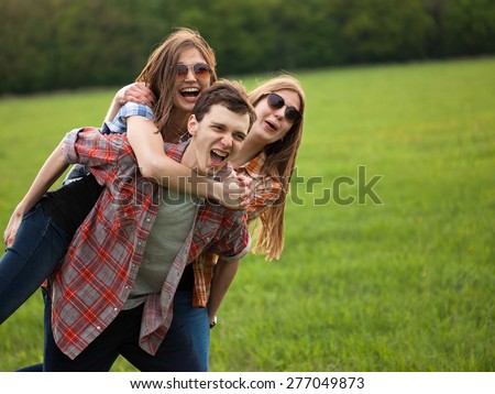 Fun outdoors. Man and two girls making fun