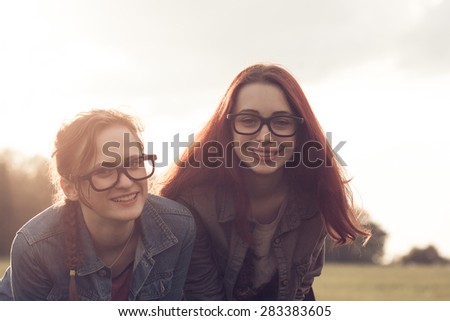 Two young girls making fun outdoors. The best friends