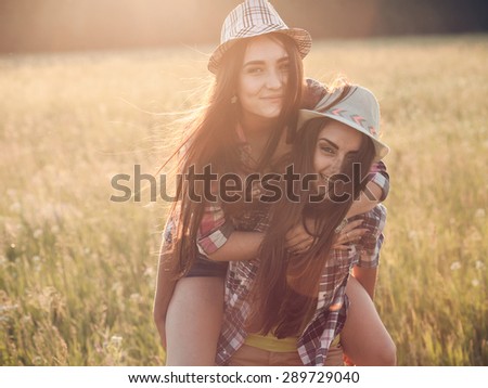 Two happiness women making fun outdoor under sunlight of sunset