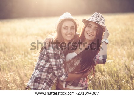 Two happiness women making fun outdoor under sunlight of sunset