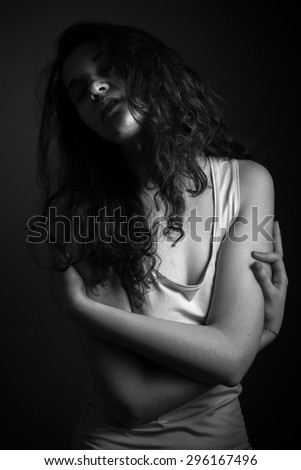 Passionate girl in the soft light. Low key. Black and white