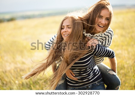 Two young women making fun outdoors