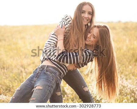 Two young women making fun outdoors