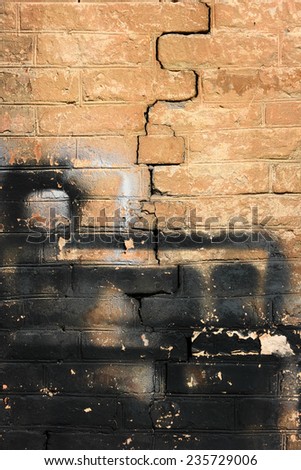 Crumbling brick wall. The shabby brick wall with a big crack.