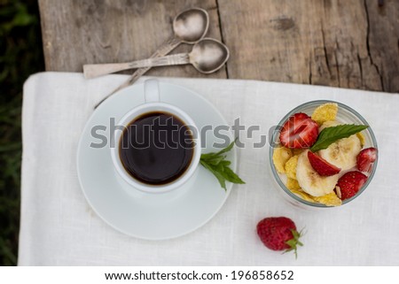 a cup of coffee and dessert  in glass  on the table
