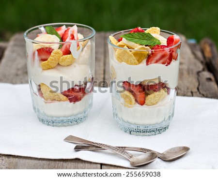 Dessert with strawberries.Cheese, strawberry, banana, cornflakes on the table. Breakfast.