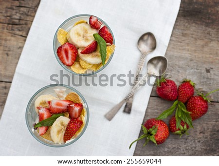Dessert with strawberries.Cheese, strawberry, banana, cornflakes on the table. Breakfast.