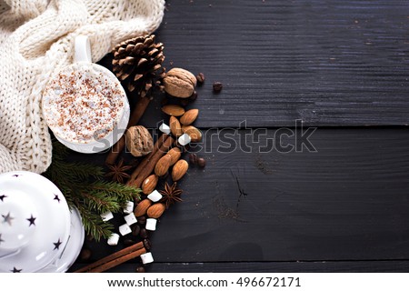 Cocoa, coffee  with marshmallows, fir branch, nuts, gift, cozy knitted blanket. Winter, New Year, Christmas still life.