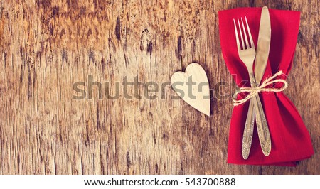 Fork, knife, napkin, heart. Celebrate valentine\'s day.  Serving, Table decoration Valentine\'s Day, table set with a decorative heart. Image of dinner on Valentines day. Top view, copy space.