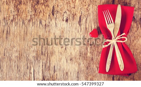 Fork, knife, napkin, heart. Celebrate valentine\'s day.  Serving, Table decoration Valentine\'s Day, table set with a decorative heart. Image of dinner on Valentines day. Top view, copy space.