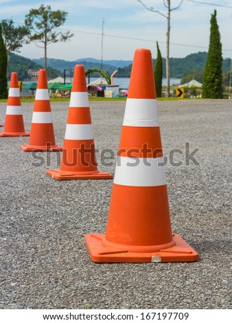 traffic warning cone in row to separate route in parking area
