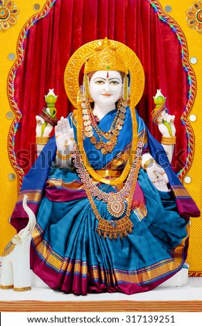 Goddess Lakshmi in Hindu temple. Lakshmi means Good Luck to Hindus, is the Goddess of wealth and prosperity. Lakshmi is the household goddess of most Hindu families, and a favorite of women.