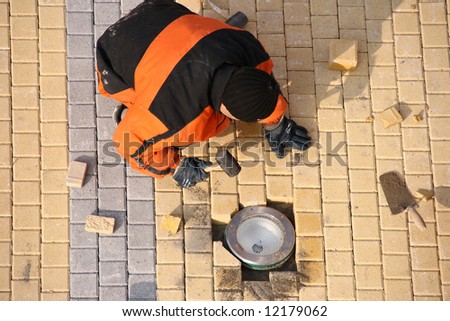 Above view of road worker making pavement