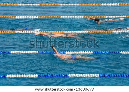 Swimming pool with swimmers training