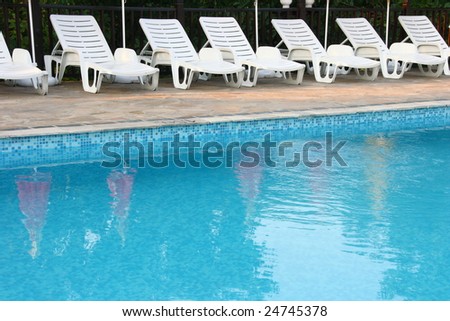 Swimming pool with comfortable chaise-longue