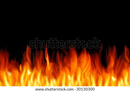 Bright fire wall on the black background. Free space for text