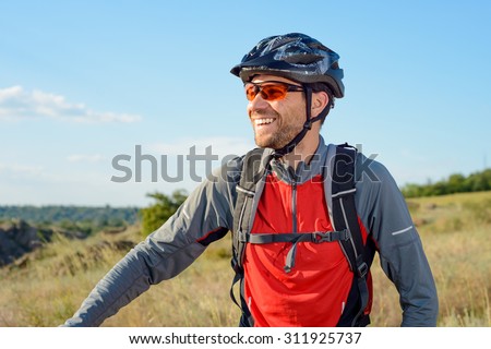 Portrait of Young Cyclist in Helmet and Glasses. Sport Lifestyle Concept.