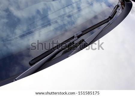 An Abstract Section Of The Front End Of A Silver Vehicle And Its Front Windscreen Bonnet And Wipers