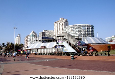DURBAN, SOUTH AFRICA - MARCH, 22, 2014 : Residential and commercial buildings and people on promenade on Golden Mile beachfront in Durban South Africa.