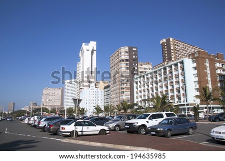 DURBAN, SOUTH AFRICA - MAY 24, 2014:  Parked motor vehicles and residential and commercial buildings on Golden Mile beachfront in Durban South Africa