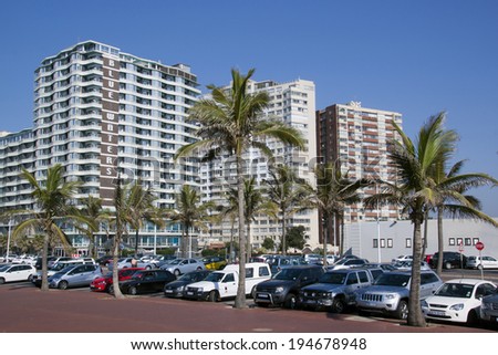 DURBAN, SOUTH AFRICA - MAY 24, 2004: vehicles and palm trees in front of residential complexes on Golden Mile Beachfront in Durban South Africa