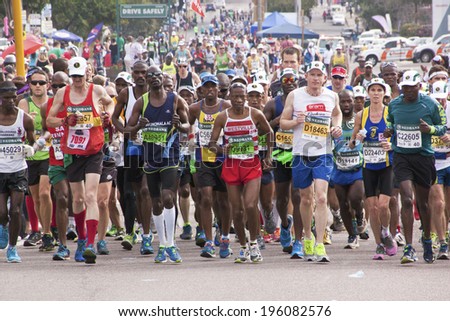 DURBAN, SOUTH AFRICA - JUNE 1, 2014: Crowd of runners competing in the long distance Comrades Marathon between Pietermaritzburg and Durban in South Africa.