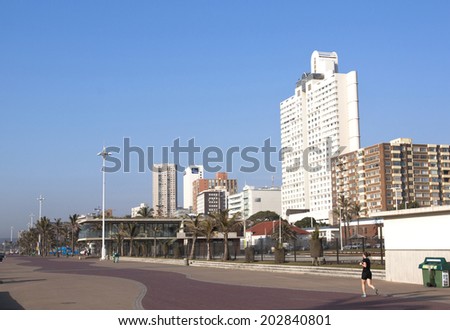 DURBAN, SOUTH AFRICA - JULY 2, 2014: Unknown Female jogs along Golden Mile beach front promenade in Durban, South Africa